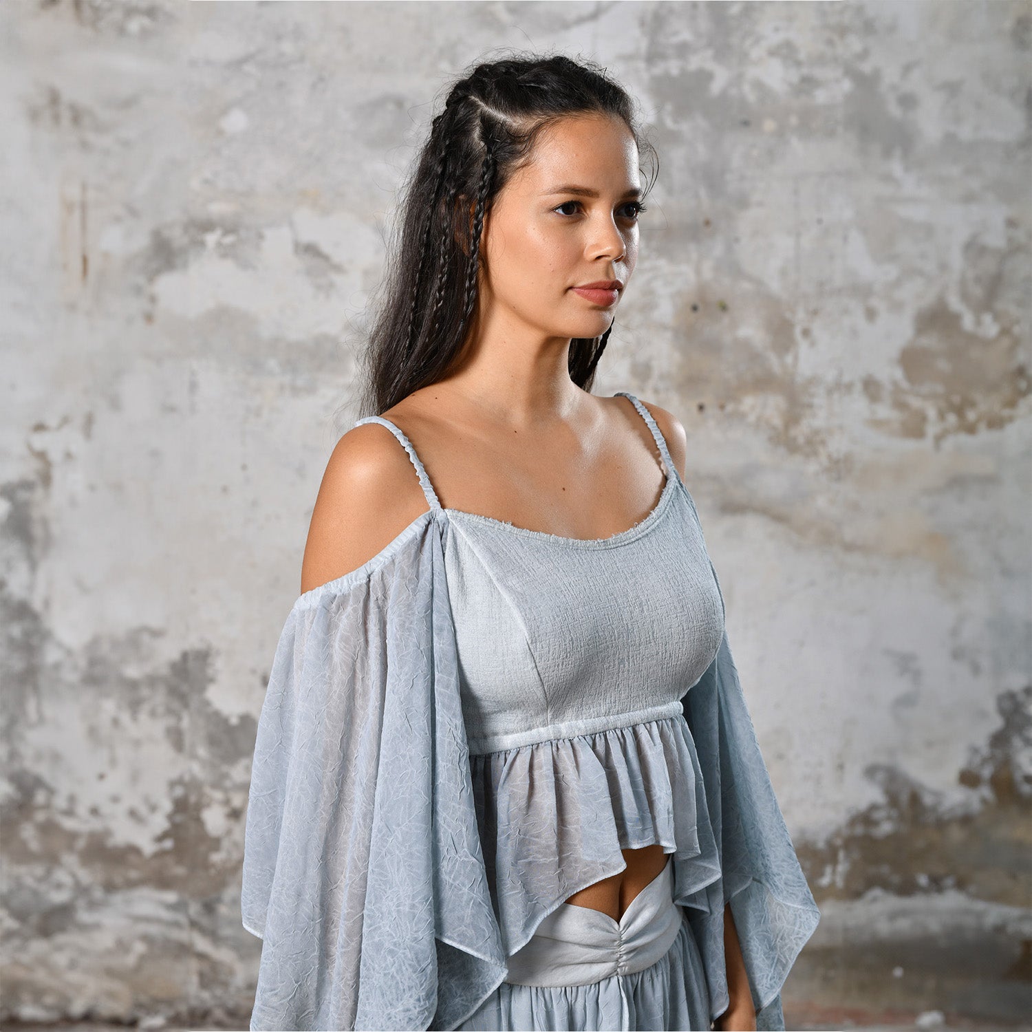 Introducing our Off-Shoulder Blue Boho Top, a symbol of effortless charm and Bohemian elegance. Crafted with an off-shoulder design, this top exudes a chic and relaxed vibe, perfect for the modern free spirit. In a serene baby blue hue, it adds a touch of ethereal beauty to any ensemble. Made from organic materials, it's a testament to sustainable fashion for the conscious woman. Embrace your inner goddess with this Gypsy-inspired piece, ideal for adding a Boho flair to your wardrobe.