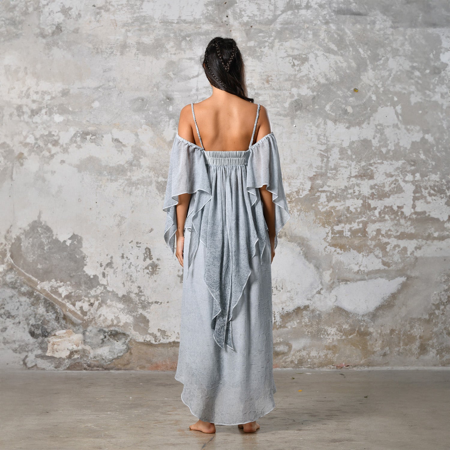 Introducing our Off-Shoulder Blue Boho Top, a symbol of effortless charm and Bohemian elegance. Crafted with an off-shoulder design, this top exudes a chic and relaxed vibe, perfect for the modern free spirit. In a serene baby blue hue, it adds a touch of ethereal beauty to any ensemble. Made from organic materials, it's a testament to sustainable fashion for the conscious woman. Embrace your inner goddess with this Gypsy-inspired piece, ideal for adding a Boho flair to your wardrobe.