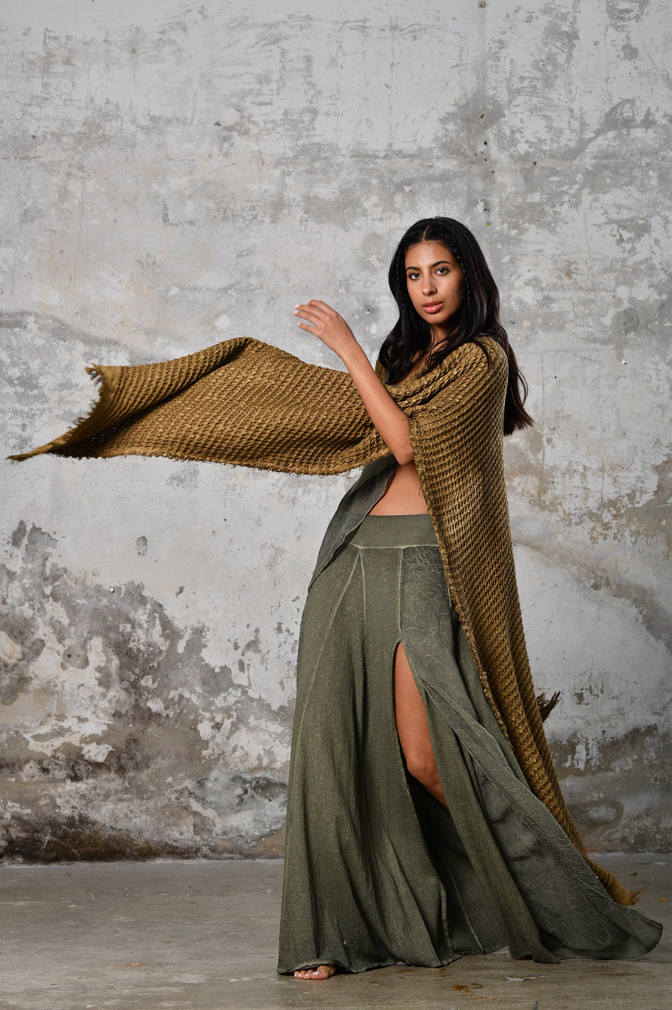 A person wearing the Waffle Poncho, a cozy bohemian-inspired garment made from Turkish cotton, in a serene autumn setting, surrounded by colorful leaves and warm hues, embodying the essence of autumn fashion and comfort.