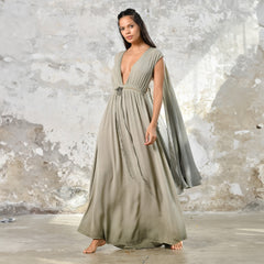 An enchanting Sage Green Greek Goddess Dress, perfect for any occasion. This elegant maxi dress features a flattering open back design, making it an ideal choice for a wedding guest or a bohemian-inspired event. The flowing, ethereal fabric and delicate details embody the essence of a Bohemian Gypsy Maxi Dress, exuding a Boho Sexy Elegant vibe.