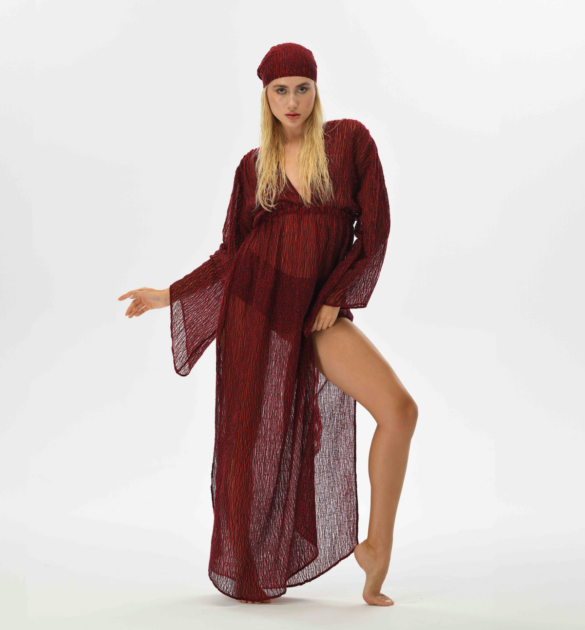 Bohemian red kaftan dress with fairy sleeves and an elastic waist for a feminine silhouette. Made from handwoven Turkish fabric, featuring a see-through, flowy design, perfect for special occasions.