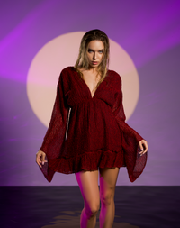 Bohemian goddess red mini dress with long sleeves, v neckline, and handwoven cotton fabric. Elastic waistband for a flattering fit. Red and black weave for a bold, artisanal touch, perfect for casual or formal wear.