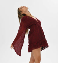 Red fairy long sleeve mini dress made from handwoven cotton with a flattering v neckline. Elastic waistband adapts to all shapes. Artisanal red and black weave for bohemian goddess fashion with a bold edge.