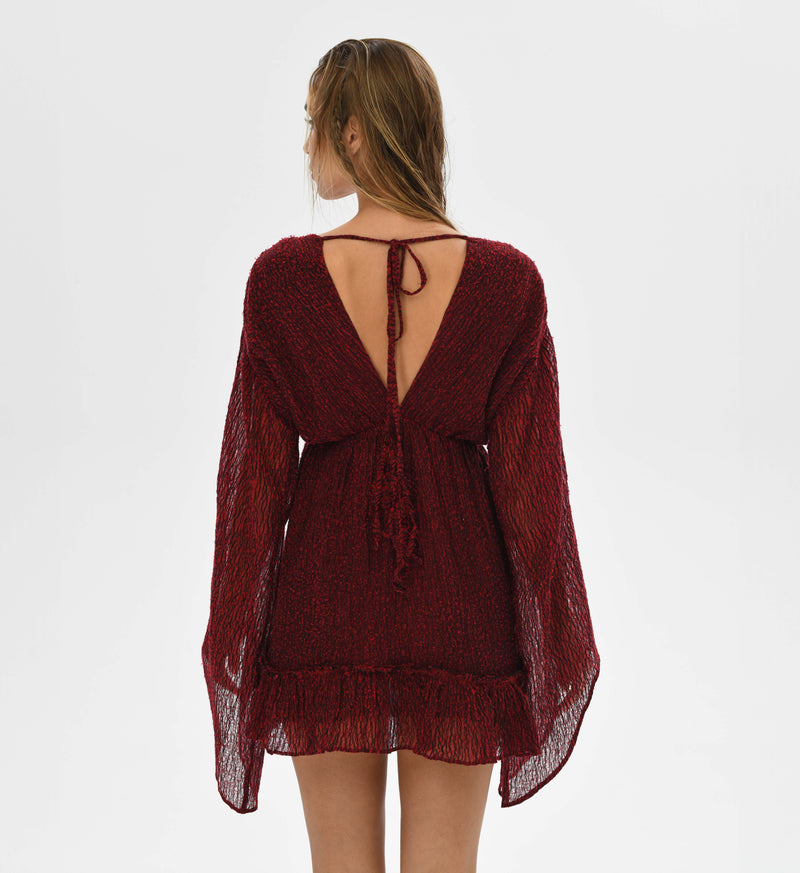 Artisanal red mini dress with long sleeves, v neckline, and elastic waistband. Handwoven cotton in red and black threads creates a unique look. Perfect for bohemian goddess style at festivals or daily wear.