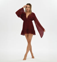 Goddess-inspired red cocktail mini dress with long sleeves and a v neckline. Handwoven cotton with an elastic waistband for a comfortable fit. Perfect for boho festivals, resort wear, and evening events.