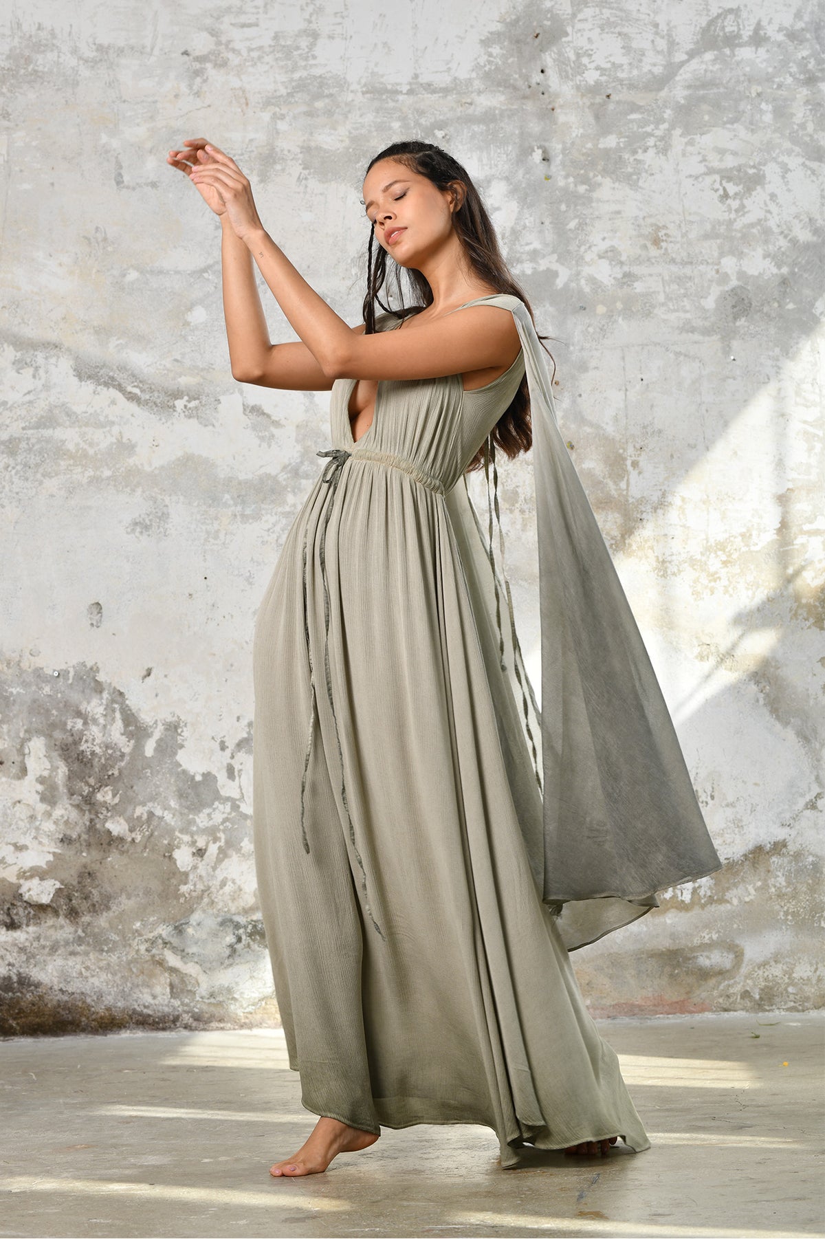 An enchanting Sage Green Greek Goddess Dress, perfect for any occasion. This elegant maxi dress features a flattering open back design, making it an ideal choice for a wedding guest or a bohemian-inspired event. The flowing, ethereal fabric and delicate details embody the essence of a Bohemian Gypsy Maxi Dress, exuding a Boho Sexy Elegant vibe.