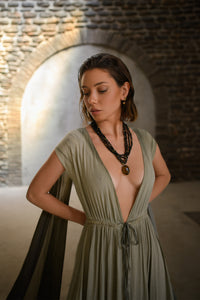 An enchanting Sage Green Greek Goddess Dress, perfect for any occasion. This elegant maxi dress features a flattering open back design, making it an ideal choice for a wedding guest or a bohemian-inspired event. The flowing, ethereal fabric and delicate details embody the essence of a Bohemian Gypsy Maxi Dress, exuding a Boho Sexy Elegant vibe.