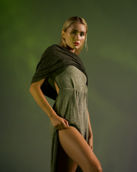 Khaki green boho hooded dress with a convertible hood-to-shawl feature, open back, and high side splits. Crafted from hand-dyed cotton and linen, offering natural elasticity for festival and casual wear.