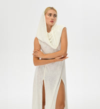 Warrior-inspired white dress with an open back, high side splits, and a hood that transforms into a shawl. Made from a hand-dyed cotton and linen blend, ideal for festival fashion.