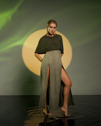 Boho festival dress in khaki green with an open back, high splits, and a versatile hood that can become a shawl. Hand-dyed with natural root dyes, made from a breathable cotton-linen blend.