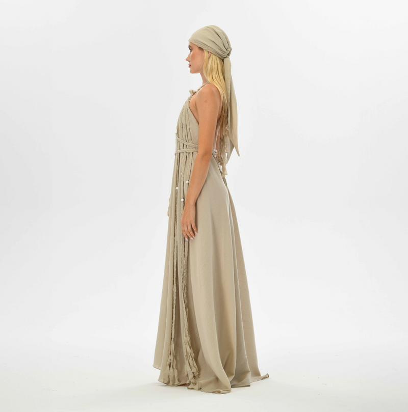 Boho chic beige maxi dress with open back, hand-braided embellishments, and a flowy design. Fits sizes XS to XL, perfect for weddings, resort vacations, or bohemian festivals.