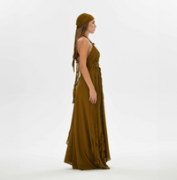 Boho chic brown maxi dress with a relaxed fit, hand-braided details, and open-back style. Ideal for weddings, festivals, and resort vacations.