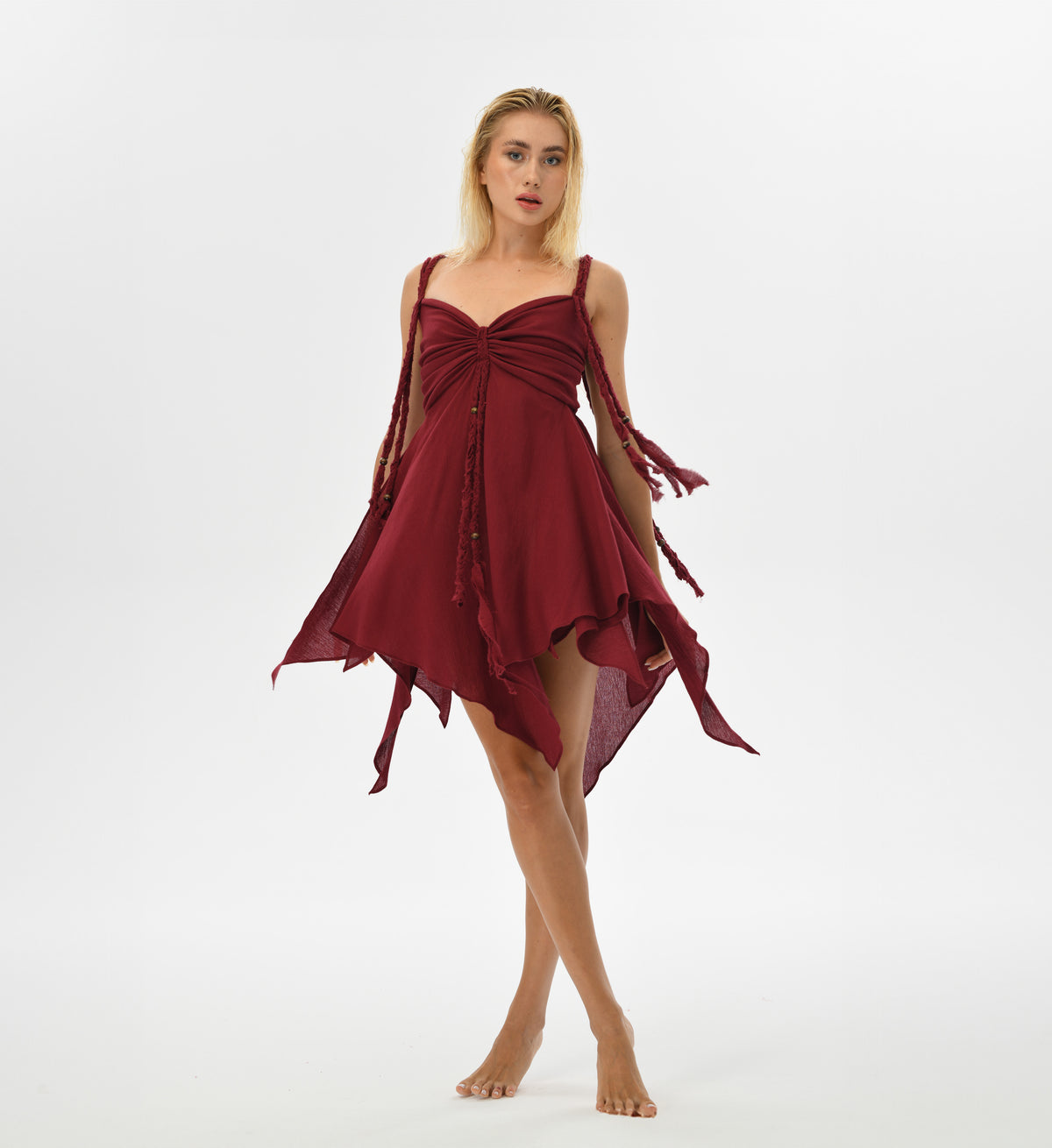 Bohemian Ninsun Mini Dress in soft, fairy-like hues, adorned with hand-braided threads. The adjustable back and corset-like top offer a blend of comfort and femininity, ideal for festival wear or casual boho chic style.