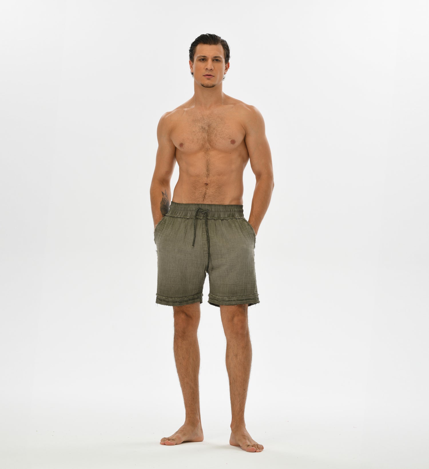 Breathable green men’s muslin shorts with a foldable hem, perfect for beachwear, festivals, or casual boho looks.