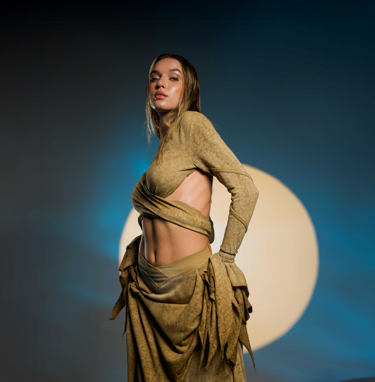 Bohemian desert sand skirt with a unique goddess cut, featuring side splits for ease of movement. This belly dance and tribal fusion-inspired skirt fits sizes XS to L with an elastic waistband.