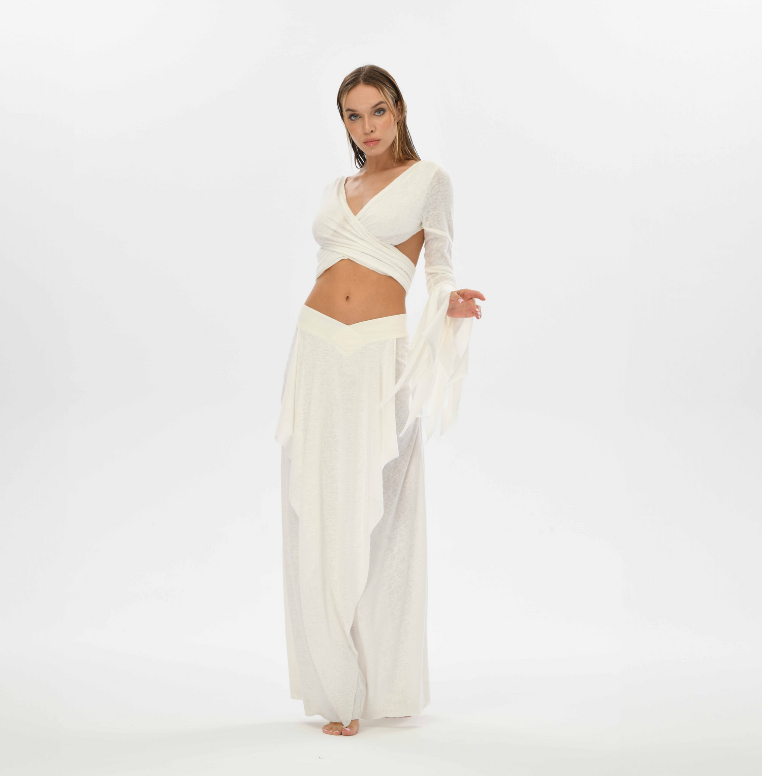 White belly dance skirt with a unique goddess cut, made from a cotton-linen blend. This gypsy-style skirt can be worn high or low waisted, featuring side splits for flexibility.