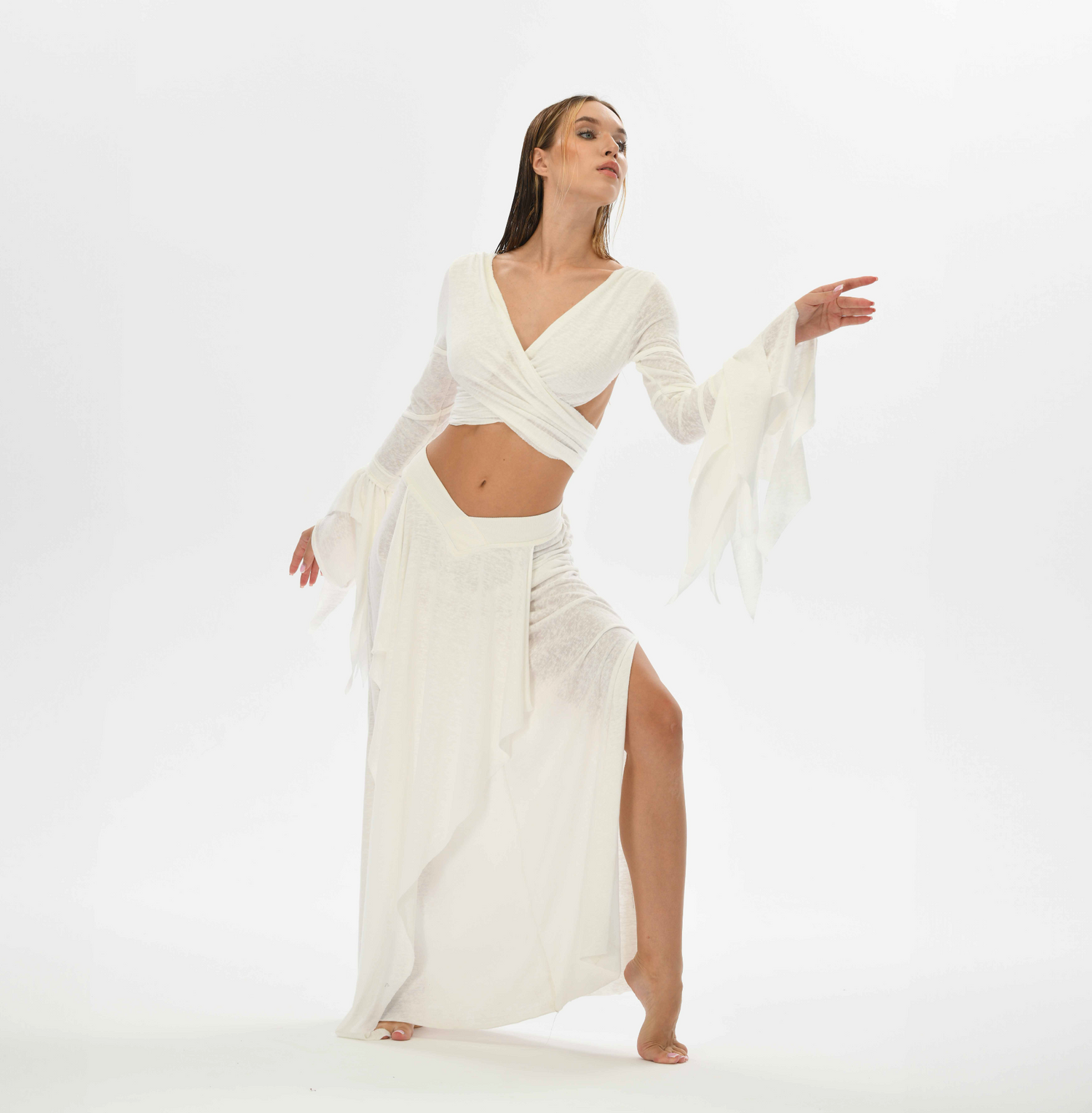 Boho chic white skirt with a goddess cut, ideal for belly dance and tribal fusion. The elastic waistband fits XS to L, with side splits for comfort and ease of movement.