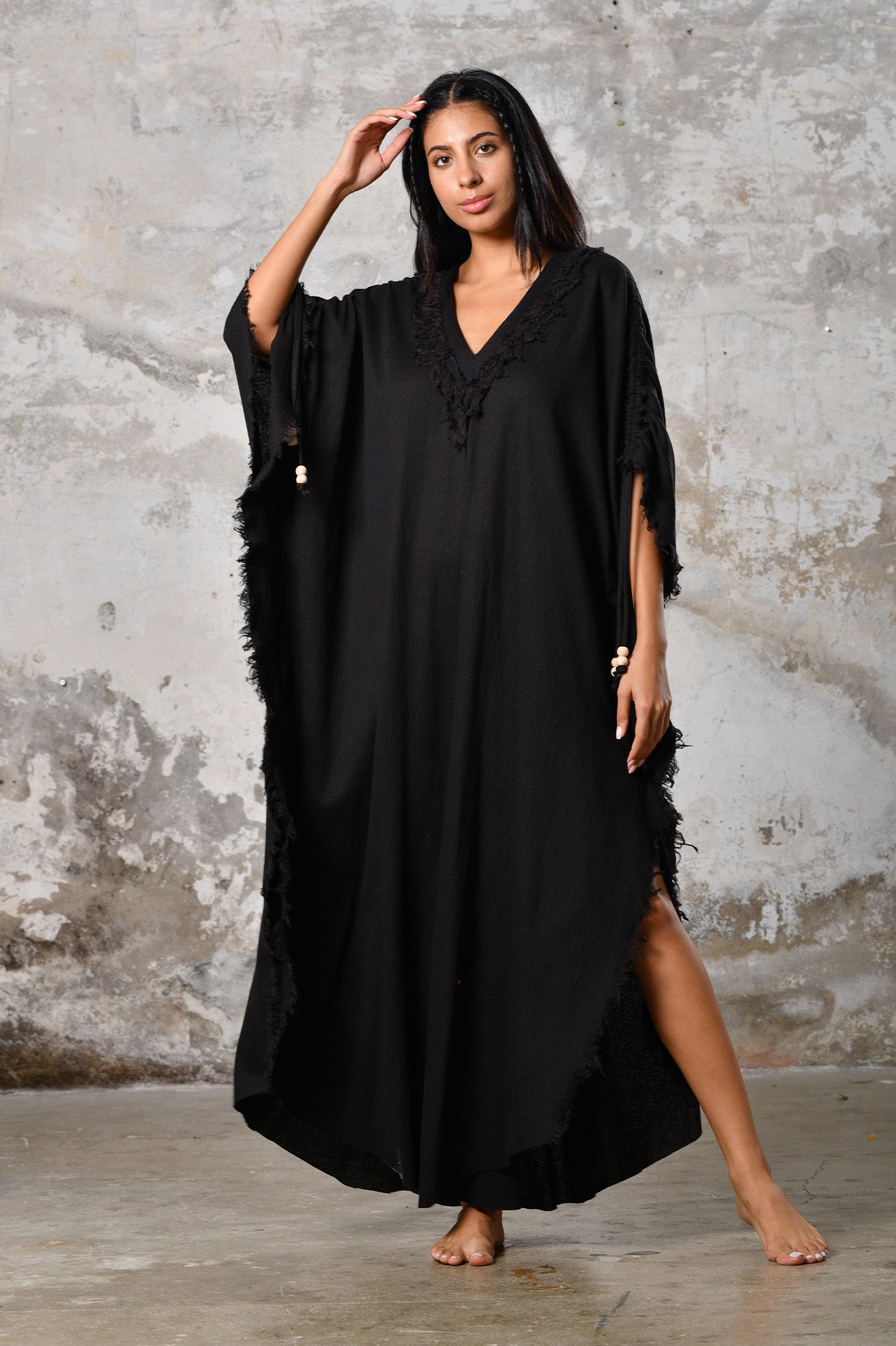 A versatile,black earthy goddess dress that embodies boho-chic style. Crafted from the softest cotton fabric, this garment offers both comfort and a fashion statement. The dress can be worn in two distinct styles, either as a kaftan or a sultry dress, with a simple change in the way you put it on. Its natural and ethereal design exudes a warm, comforting feeling against your skin, making it a must-have addition to your wardrobe for those seeking a harmonious blend of style and comfort.