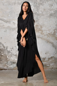 A versatile,black earthy goddess dress that embodies boho-chic style. Crafted from the softest cotton fabric, this garment offers both comfort and a fashion statement. The dress can be worn in two distinct styles, either as a kaftan or a sultry dress, with a simple change in the way you put it on. Its natural and ethereal design exudes a warm, comforting feeling against your skin, making it a must-have addition to your wardrobe for those seeking a harmonious blend of style and comfort.