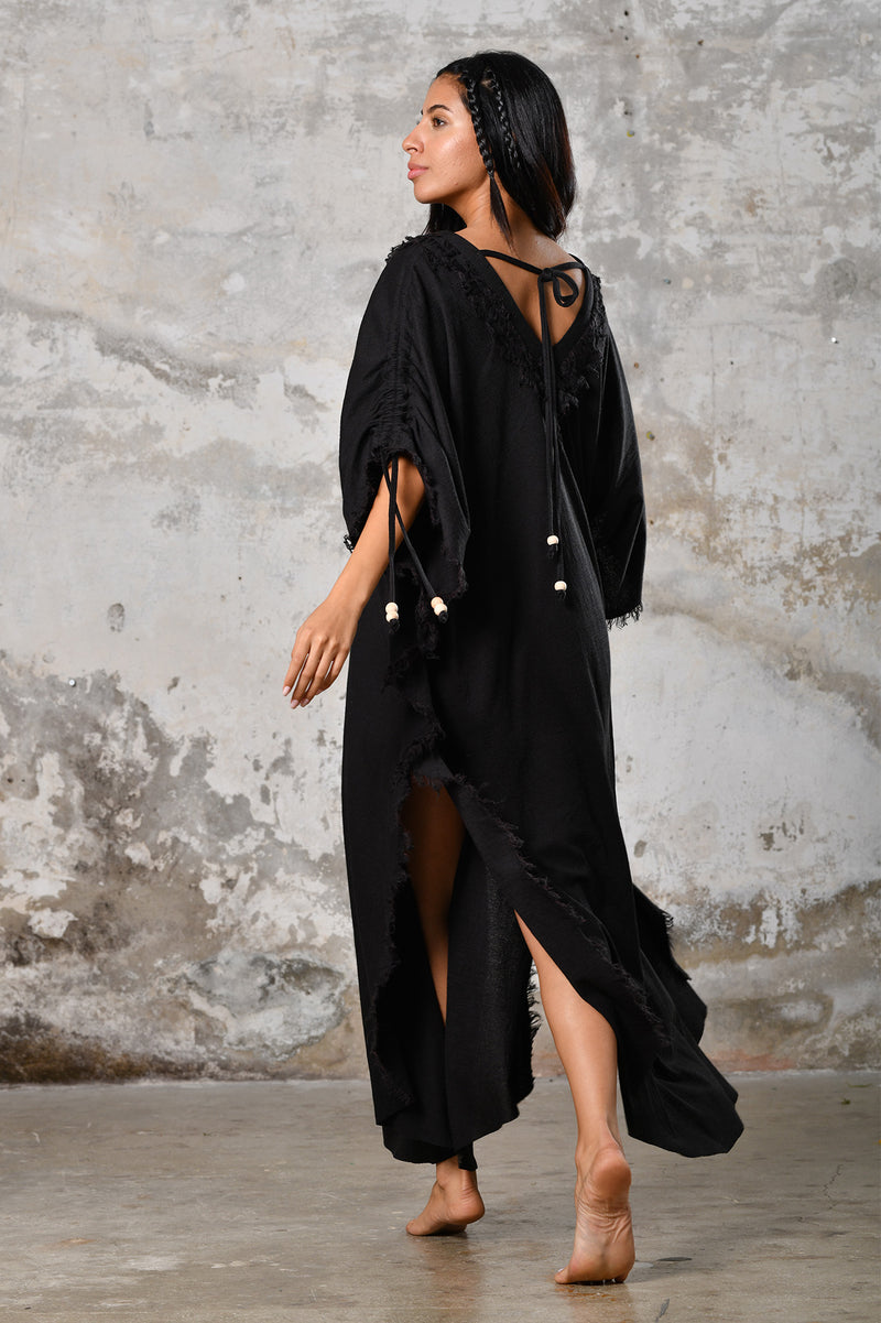 A versatile,black earthy goddess dress that embodies boho-chic style. Crafted from the softest cotton fabric, this garment offers both comfort and a fashion statement. The dress can be worn in two distinct styles, either as a kaftan or a sultry dress, with a simple change in the way you put it on. Its natural and ethereal design exudes a warm, comforting feeling against your skin, making it a must-have addition to your wardrobe for those seeking a harmonious blend of style and comfort.