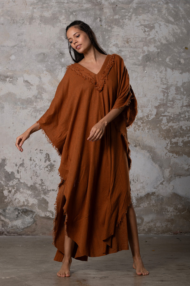 A versatile, earthy goddess dress that embodies boho-chic style. Crafted from the softest cotton fabric, this garment offers both comfort and a fashion statement. The dress can be worn in two distinct styles, either as a kaftan or a sultry dress, with a simple change in the way you put it on. Its natural and ethereal design exudes a warm, comforting feeling against your skin, making it a must-have addition to your wardrobe for those seeking a harmonious blend of style and comfort.