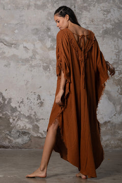 A versatile, earthy goddess dress that embodies boho-chic style. Crafted from the softest cotton fabric, this garment offers both comfort and a fashion statement. The dress can be worn in two distinct styles, either as a kaftan or a sultry dress, with a simple change in the way you put it on. Its natural and ethereal design exudes a warm, comforting feeling against your skin, making it a must-have addition to your wardrobe for those seeking a harmonious blend of style and comfort.