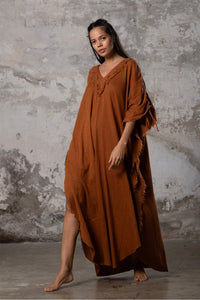 A versatile, earthy goddess dress that embodies boho-chic style. Crafted from the softest cotton fabric, this garment offers both comfort and a fashion statement. The dress can be worn in two distinct styles, either as a kaftan or a sultry dress, with a simple change in the way you put it on. Its natural and ethereal design exudes a warm, comforting feeling against your skin, making it a must-have addition to your wardrobe for those seeking a harmonious blend of style and comfort.