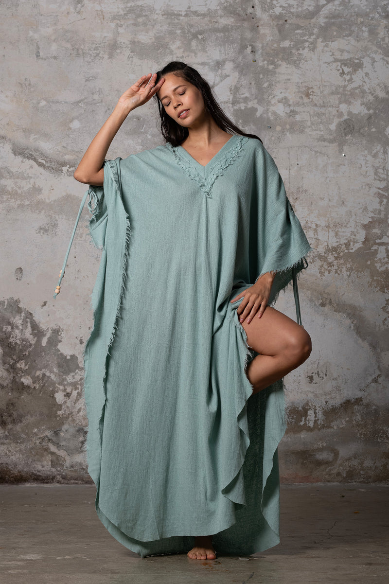 A versatile, earthy goddess dress that embodies boho-chic style. Crafted from the softest cotton fabric, this garment offers both comfort and a fashion statement. The dress can be worn in two distinct styles, either as a kaftan or a sultry dress, with a simple change in the way you put it on. Its natural and ethereal design exudes a warm, comforting feeling against your skin, making it a must-have addition to your wardrobe for those seeking a harmonious blend of style and comfort.