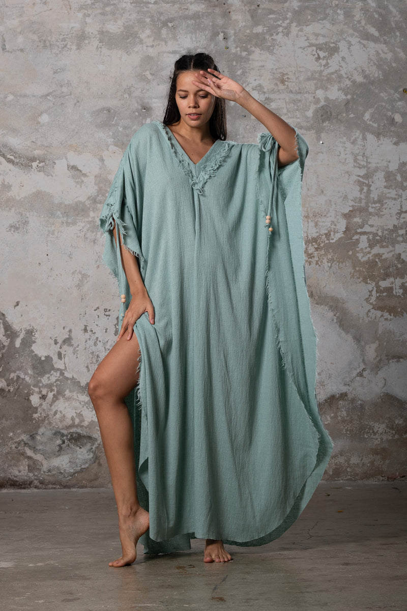 A versatile, earthy goddess dress that embodies boho-chic style. Crafted from the softest cotton fabric, this garment offers both comfort and a fashion statement. The dress can be worn in two distinct styles, either as a kaftan or a sultry dress, with a simple change in the way you put it on. Its natural and ethereal design exudes a warm, comforting feeling against your skin, making it a must-have addition to your wardrobe for those seeking a harmonious blend of style and comfort.