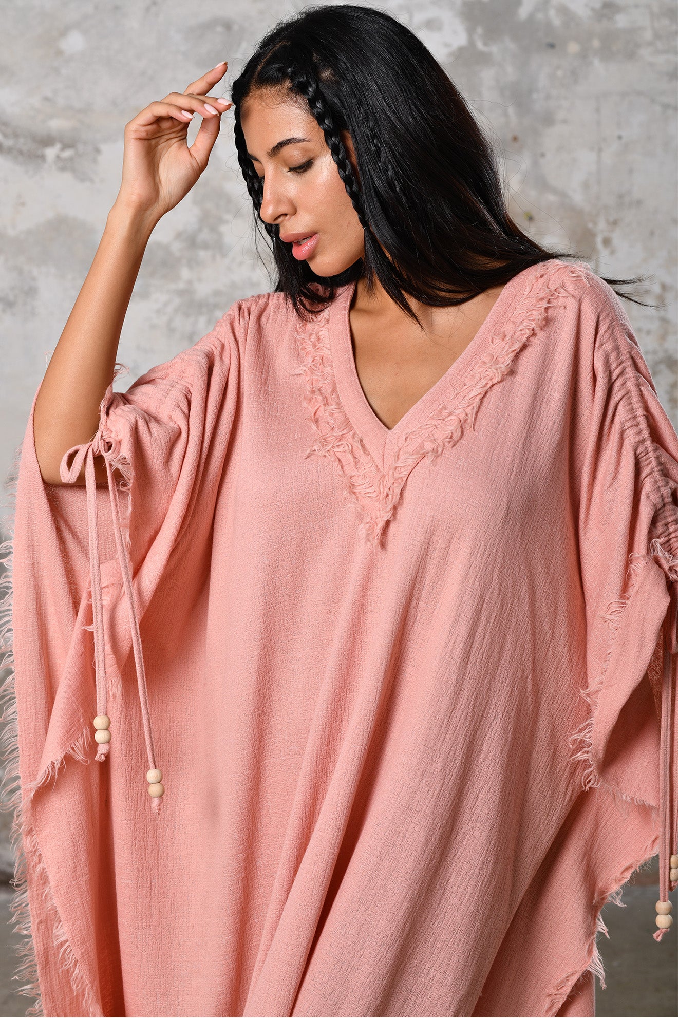 A versatile, pink earthy goddess dress that embodies boho-chic style. Crafted from the softest cotton fabric, this garment offers both comfort and a fashion statement. The dress can be worn in two distinct styles, either as a kaftan or a sultry dress, with a simple change in the way you put it on. Its natural and ethereal design exudes a warm, comforting feeling against your skin, making it a must-have addition to your wardrobe for those seeking a harmonious blend of style and comfort.