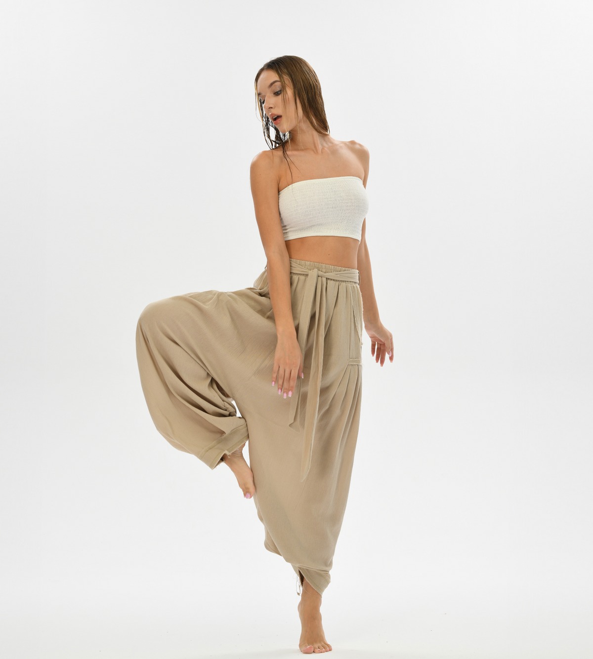 Bohemian-inspired beige pants with a harem cut, crafted from cotton for ultimate comfort, ideal for casual wear or yoga.