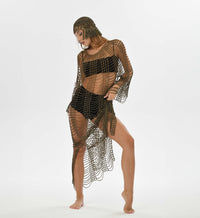 Hand-crocheted bohemian dress with gold accents, featuring a flowy, transparent design perfect for beach resorts.