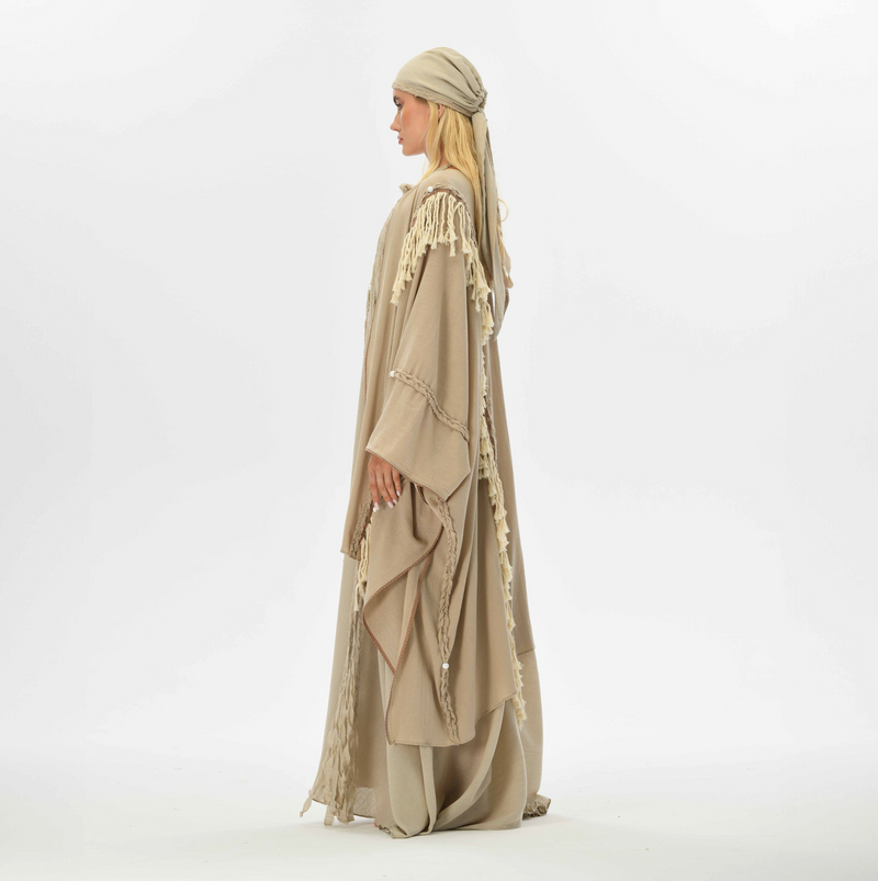 Beige boho cape with fringes and braided details, made from organic cotton, perfect for women’s casual boho chic style.