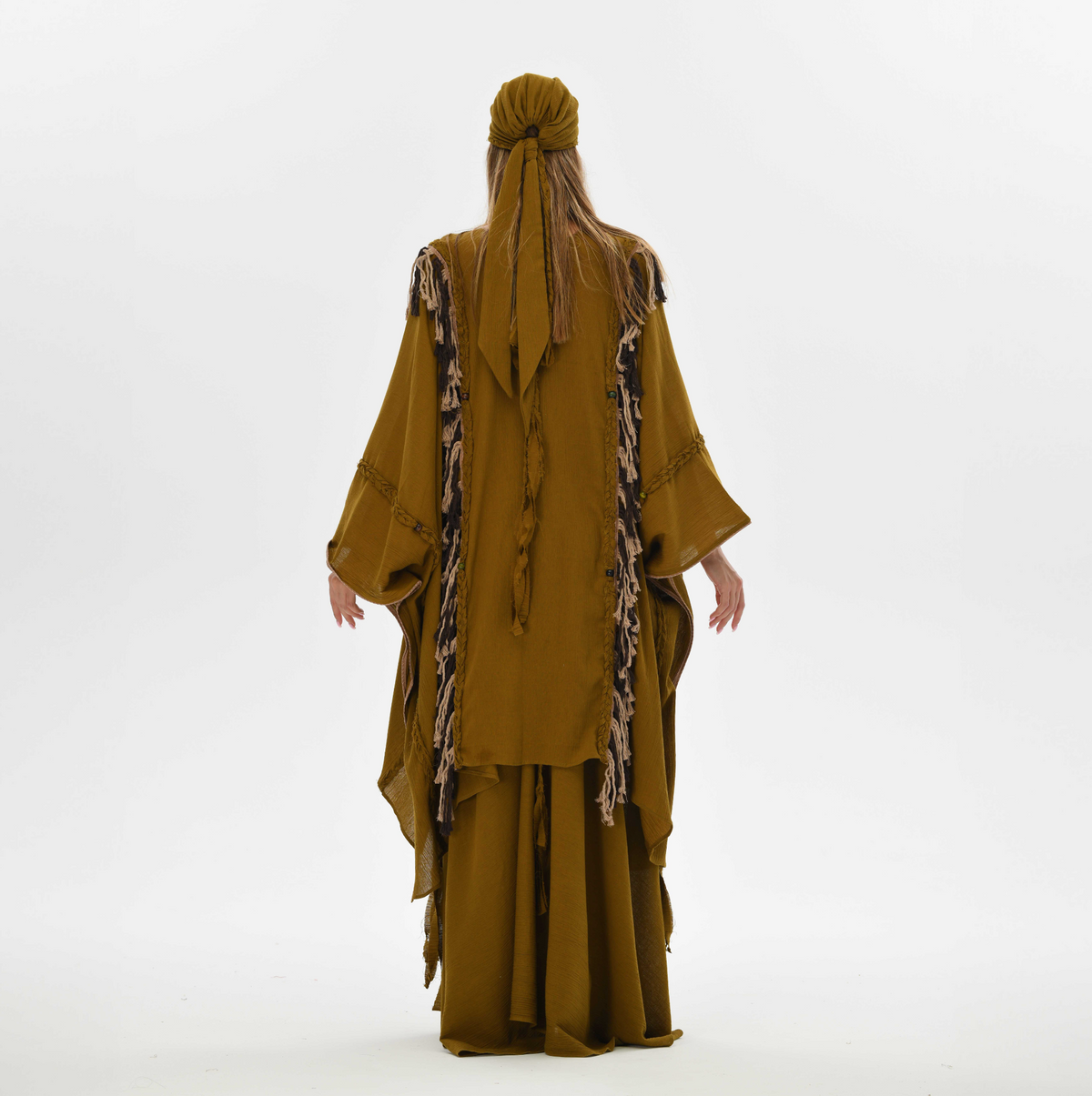 Organic cotton poncho for women in brown, designed with fringe and handmade tassels, perfect for layering at festivals or casual outings.