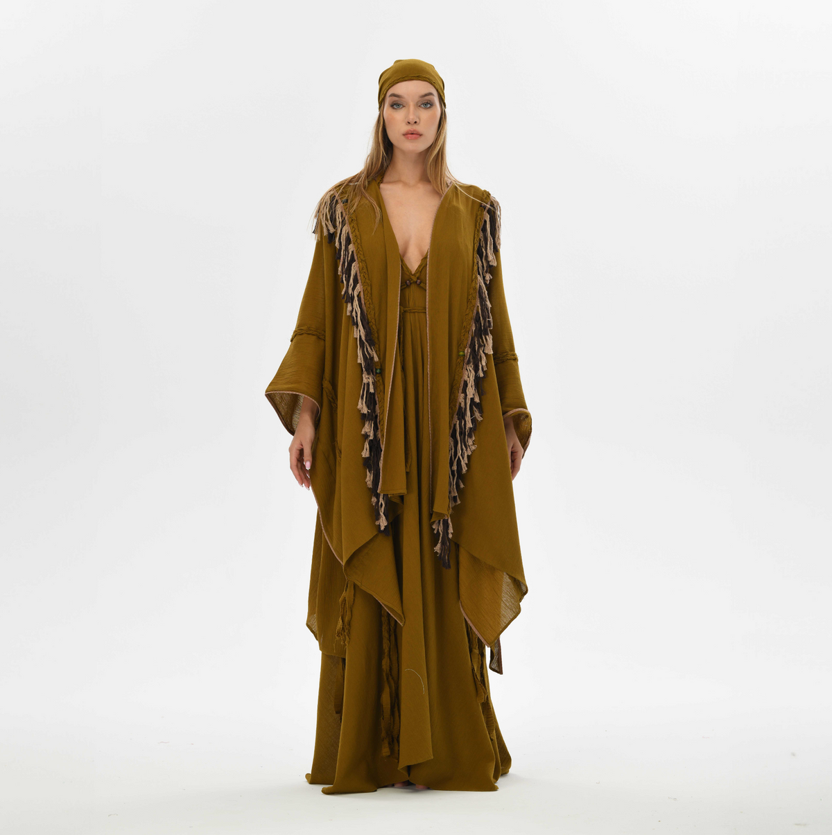 Organic cotton poncho for women in brown, designed with fringe and handmade tassels, perfect for layering at festivals or casual outings.