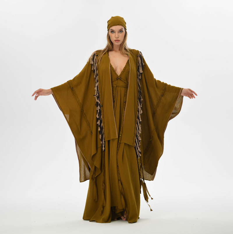 Organic cotton poncho for women in brown, designed with fringe and handmade tassels, perfect for layering at festivals or casual outings.