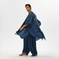 Fringed boho poncho for men, designed with braided details and handmade tassels in navy blue organic cotton, perfect for festivals or casual wear.