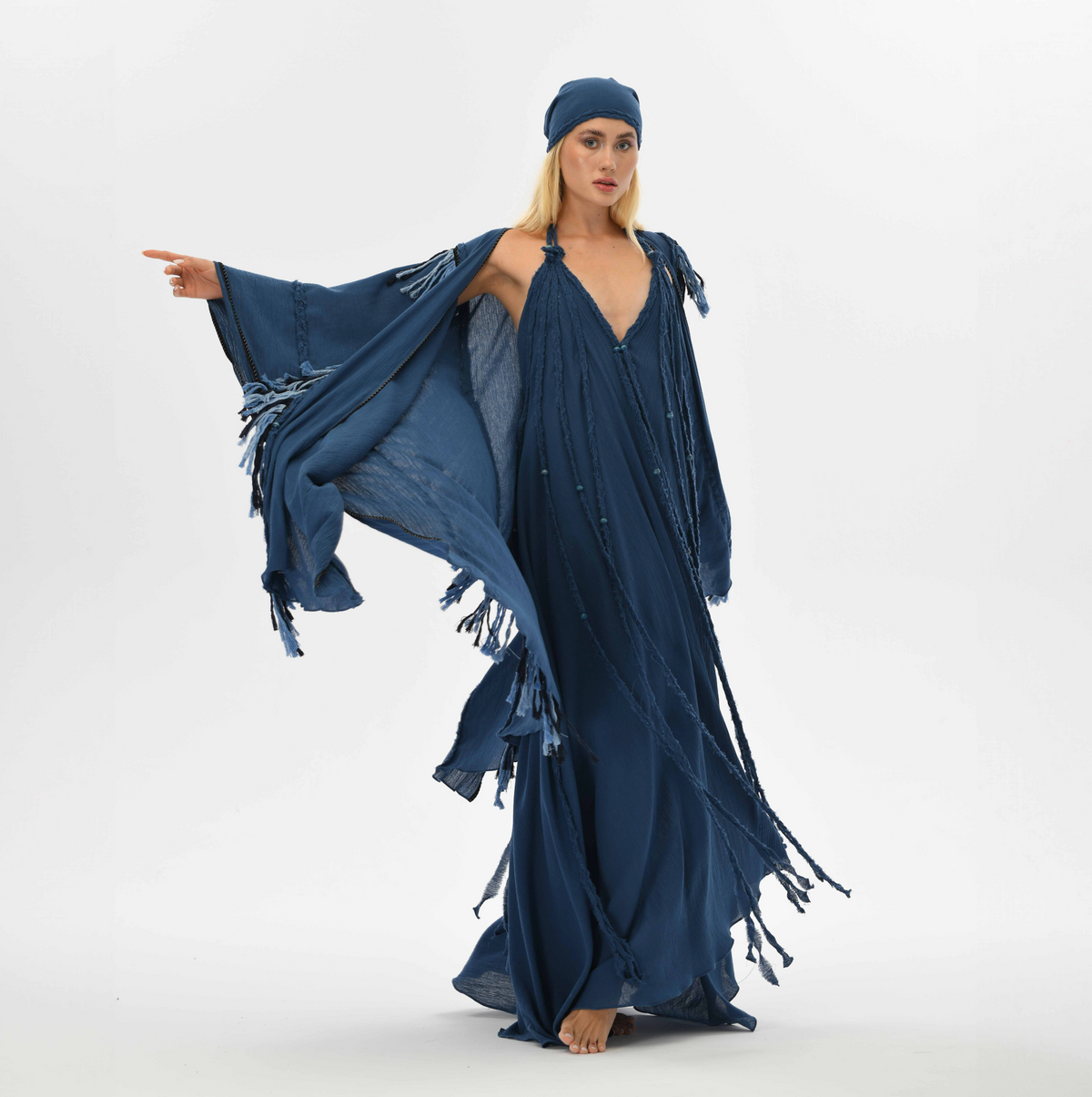 Boho chic poncho for men, crafted from navy blue organic cotton with fringe and braided details, perfect for festivals or casual shamanic-inspired style.