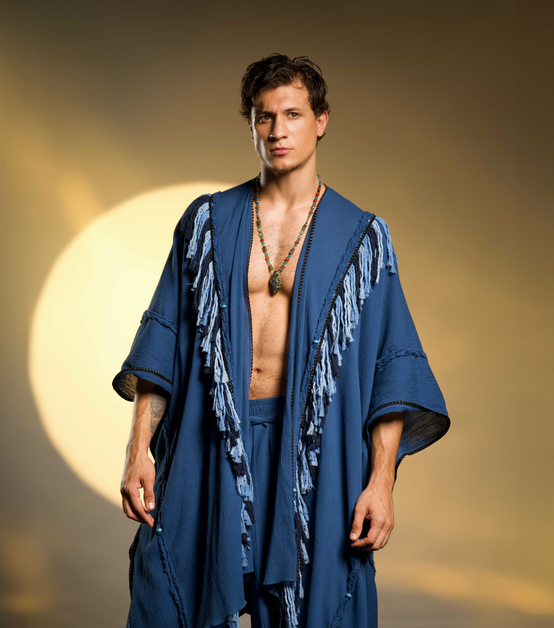 Fringed boho poncho for men, designed with braided details and handmade tassels in navy blue organic cotton, perfect for festivals or casual wear.