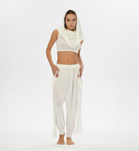 Loose white harem pants with gypsy style, crafted from a soft linen-cotton blend. These pants feature an elastic waistband and are perfect for festivals, boho style, or lounging.