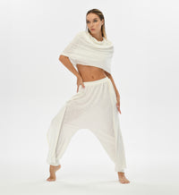 Gypsy style white harem pants with a relaxed fit. Crafted from linen-cotton blend with an elastic waistband, these pants are perfect for festivals, casual boho outfits, or lounging at home.