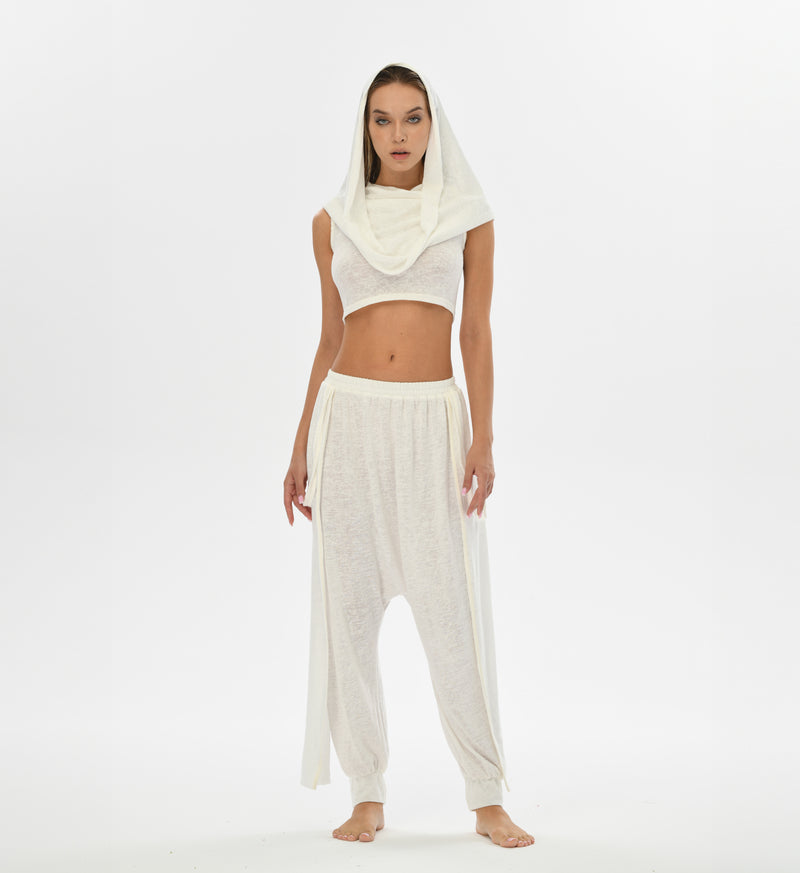 Alchemist-inspired white harem pants made from linen and cotton, designed for comfort and style. Perfect for boho chic outfits, festivals, and casual daywear. Elastic waistband for flexible sizing.