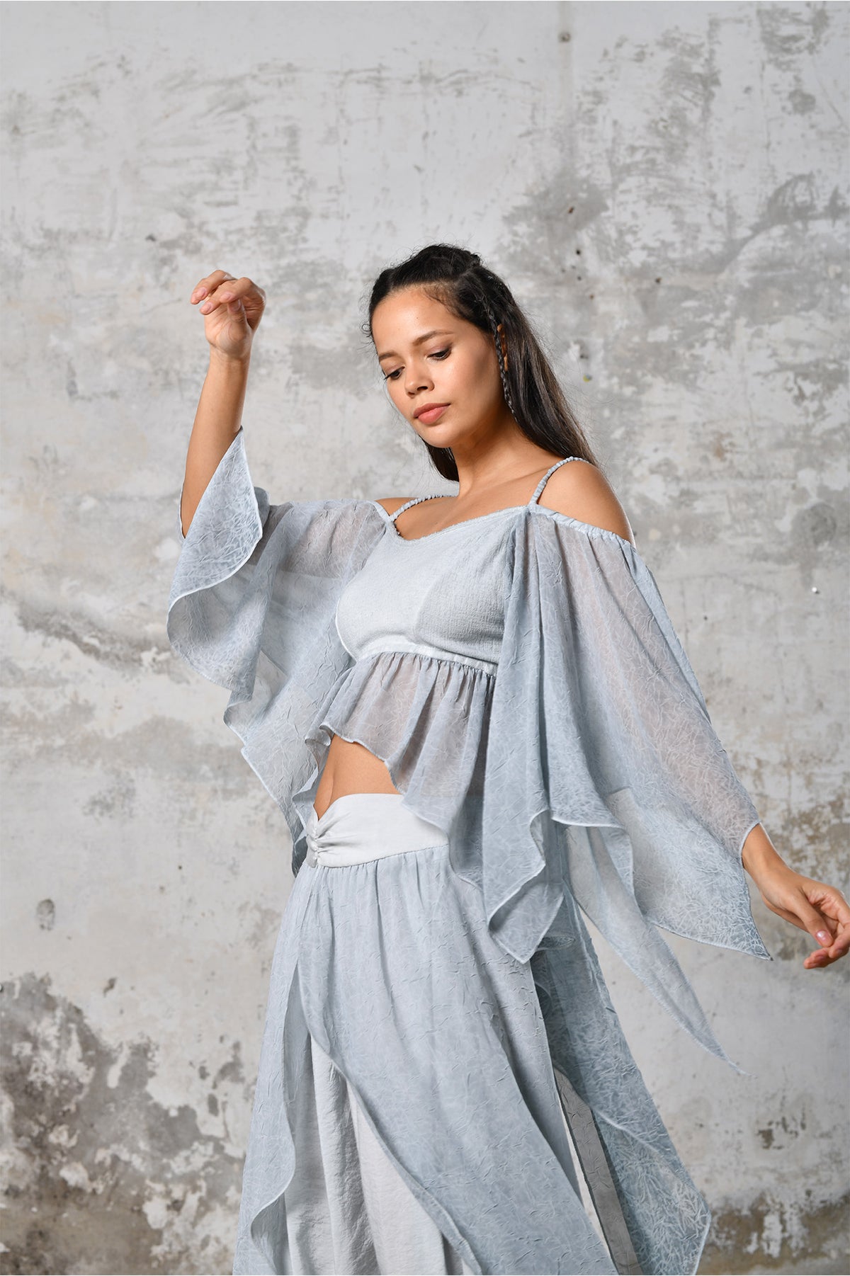 An enchanting Bohemian Venus BLUE, perfect for boho and festival-inspired looks, exuding a goddess-like quality. The flowy fabric and intricate side details create an ethereal, bohemian style perfect for Burning Man and other occasions. This garment is an ethically crafted gem