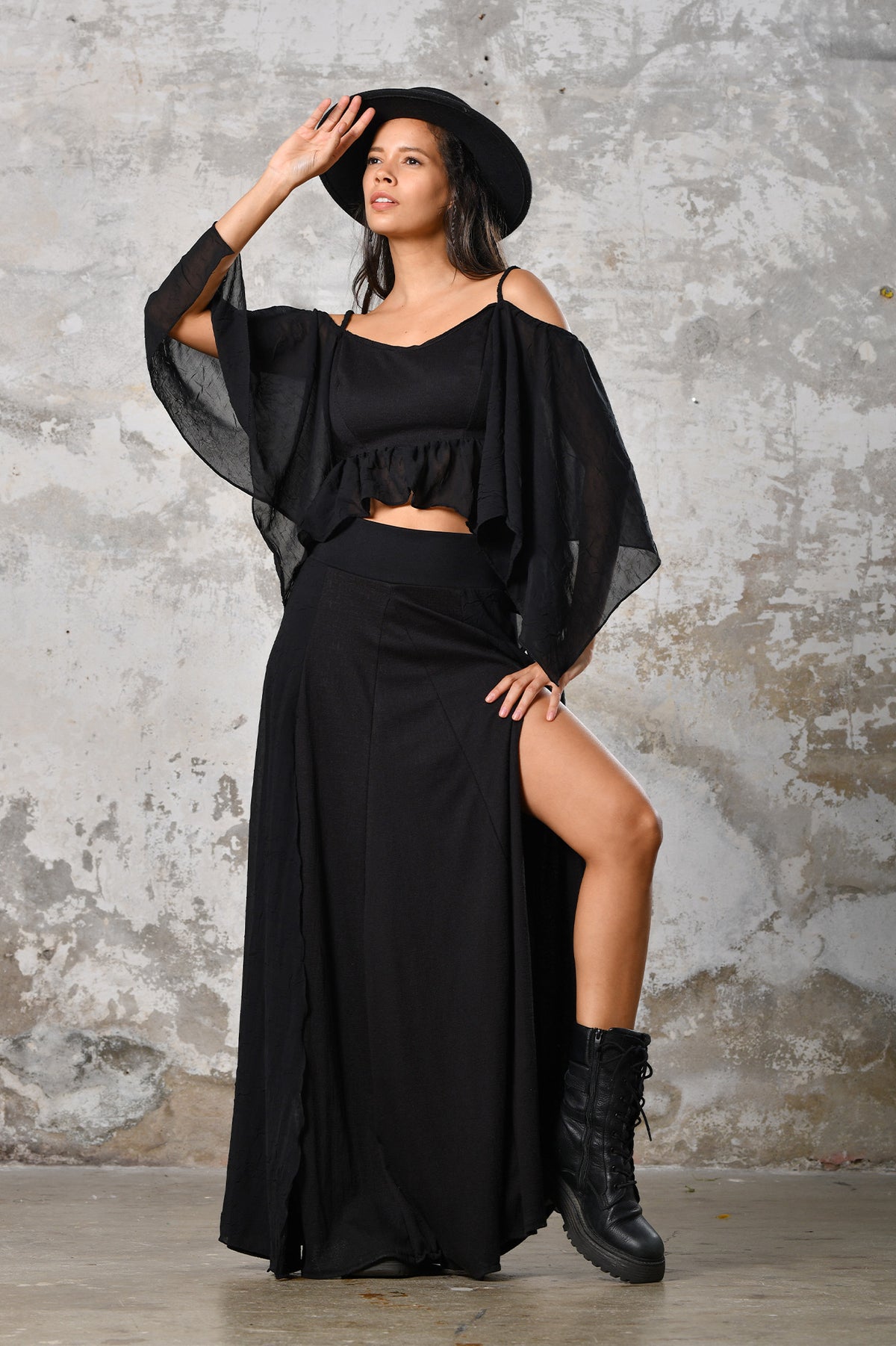 An enchanting Bohemian Venus black blouse, perfect for boho and festival-inspired looks, exuding a goddess-like quality. The flowy fabric and intricate side details create an ethereal, bohemian style perfect for Burning Man and other occasions. This garment is an ethically crafted gem