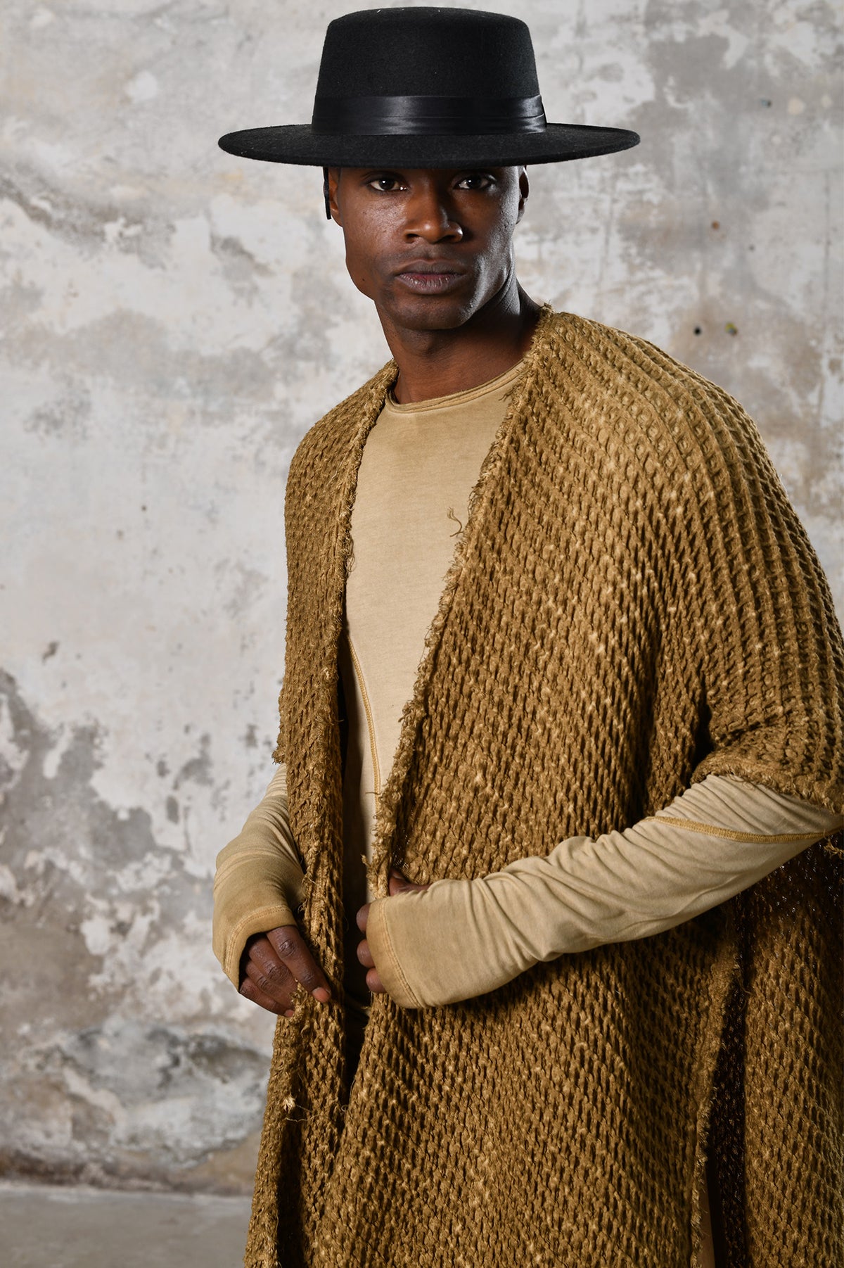 A person wearing the Waffle Poncho, a cozy bohemian-inspired garment made from Turkish cotton, in a serene autumn setting, surrounded by colorful leaves and warm hues, embodying the essence of autumn fashion and comfort.