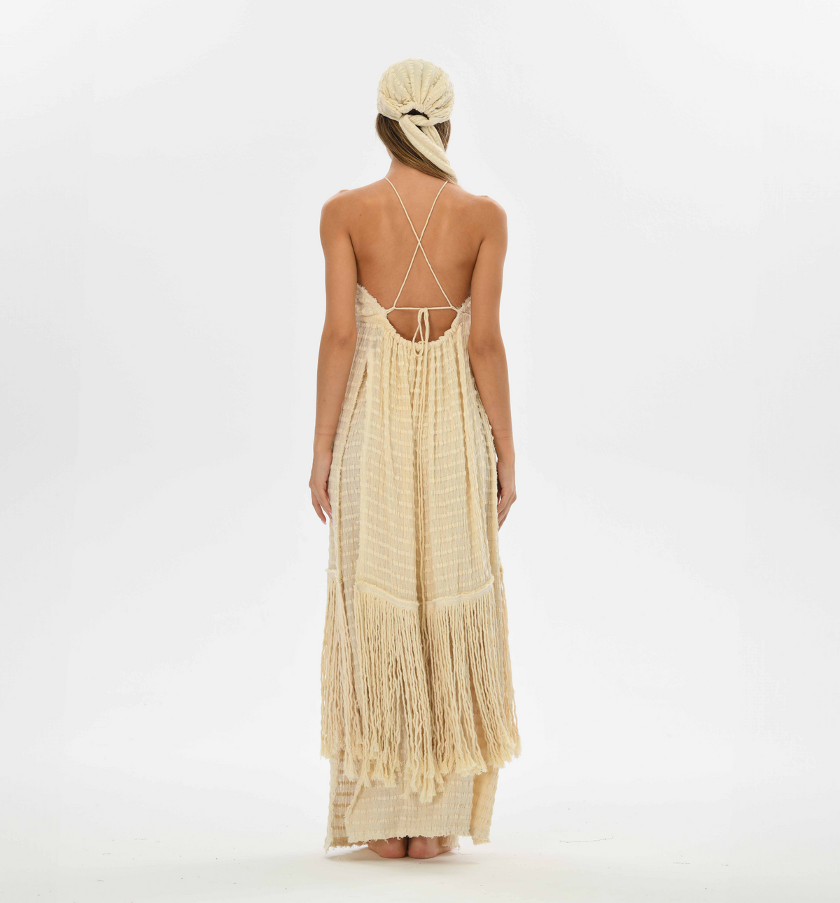 Handwoven cotton fringe top with a tie front and open back, perfect for layering over boho dresses or festival outfits.