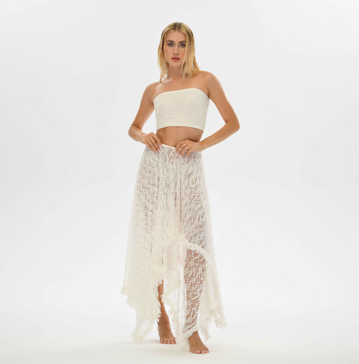 Flowy white lace skirt, perfect for bohemian-inspired outfits, featuring an elastic waist for a comfortable fit.