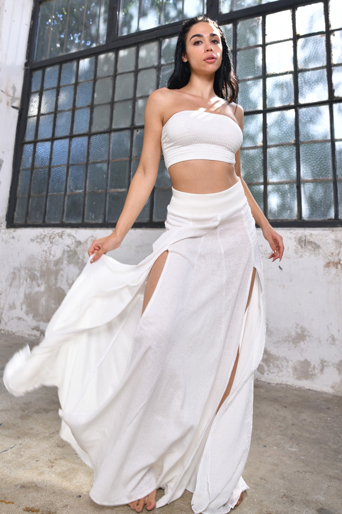 white sexy and dramatic split design, high-quality rayon fabric, comfortable elastic waistband, range of colors, one size fits most, effortlessly chic bohemian style, summer festivals, beach parties, versatile dress up or down style, boho goddess skirt, grecian goddess skirt, bohemian style